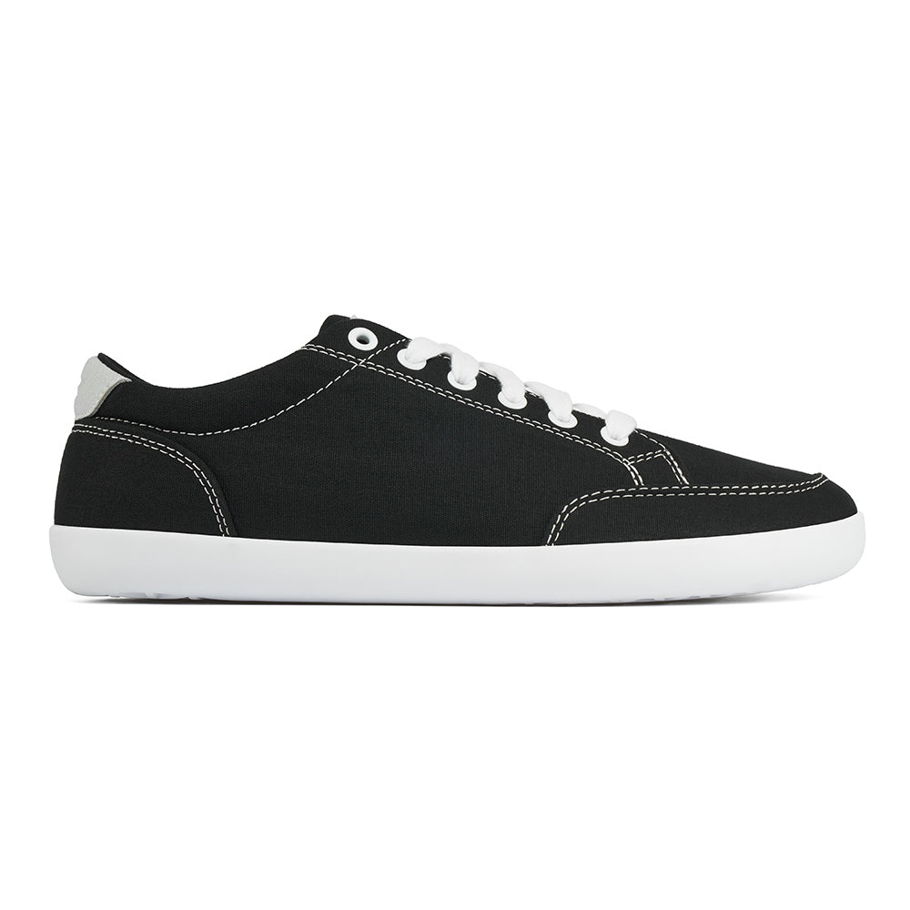 Side picture of the FREESTYLE 3 Coal, Black sneaker with white laces on a white background