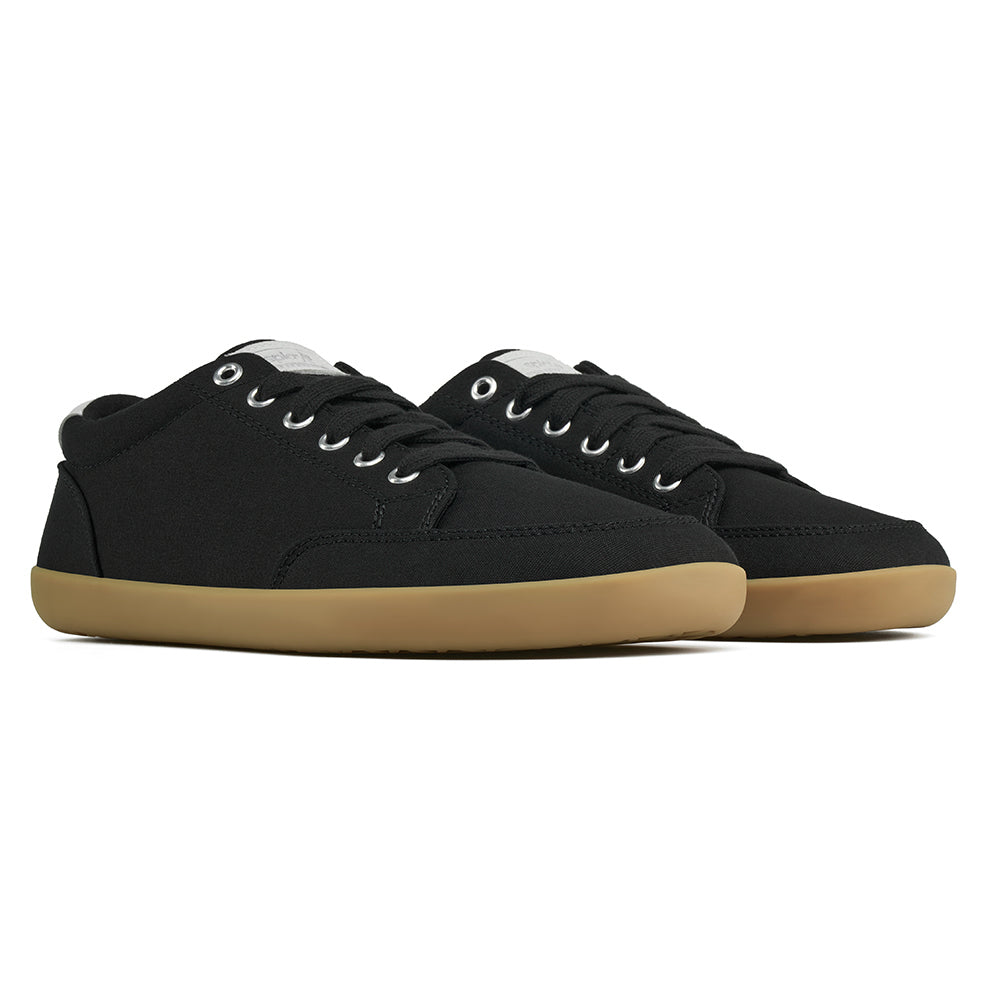Front angle view of the FREESTYLE 3 Shale, black sneaker with black laces, and brown gumsole, on a white background
