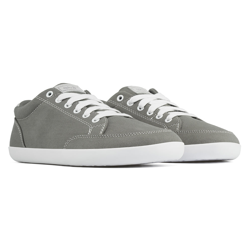Front angle view of the FREESTYLE 3 Stone, grey sneaker with white laces, and white outsole, on a white background