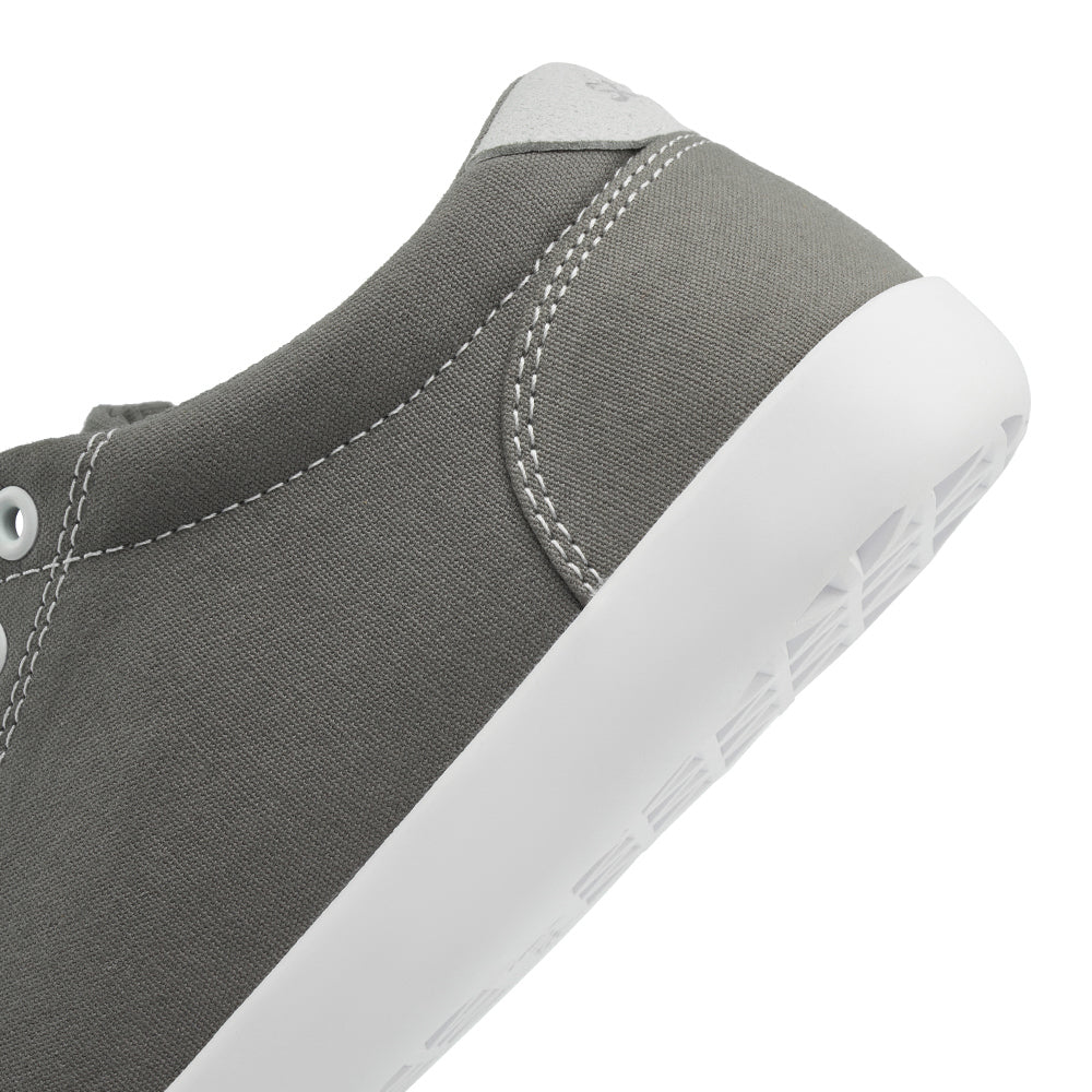 Close up view of the back half of the FREESTYLE 3 Stone, grey sneaker with white eyelets and light grey accents on a white background