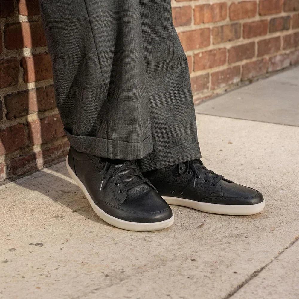 Professional wearing black Splay FREESTYLE Leather barefoot sneakers with tailored trousers in a modern business casual office.