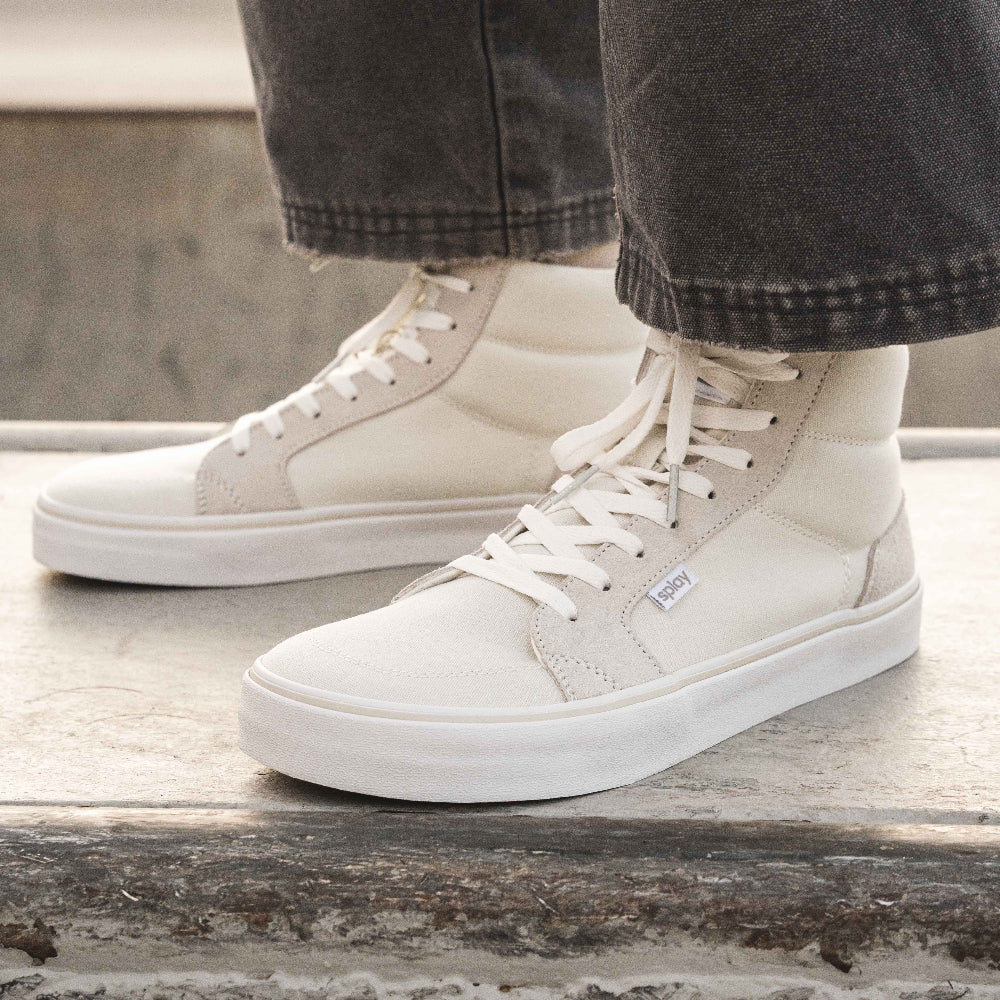 Model wearing Splay Freestyle Hi-Top barefoot shoes in Off-White Canvas, showcasing a foot-shaped design and casual everyday style.
