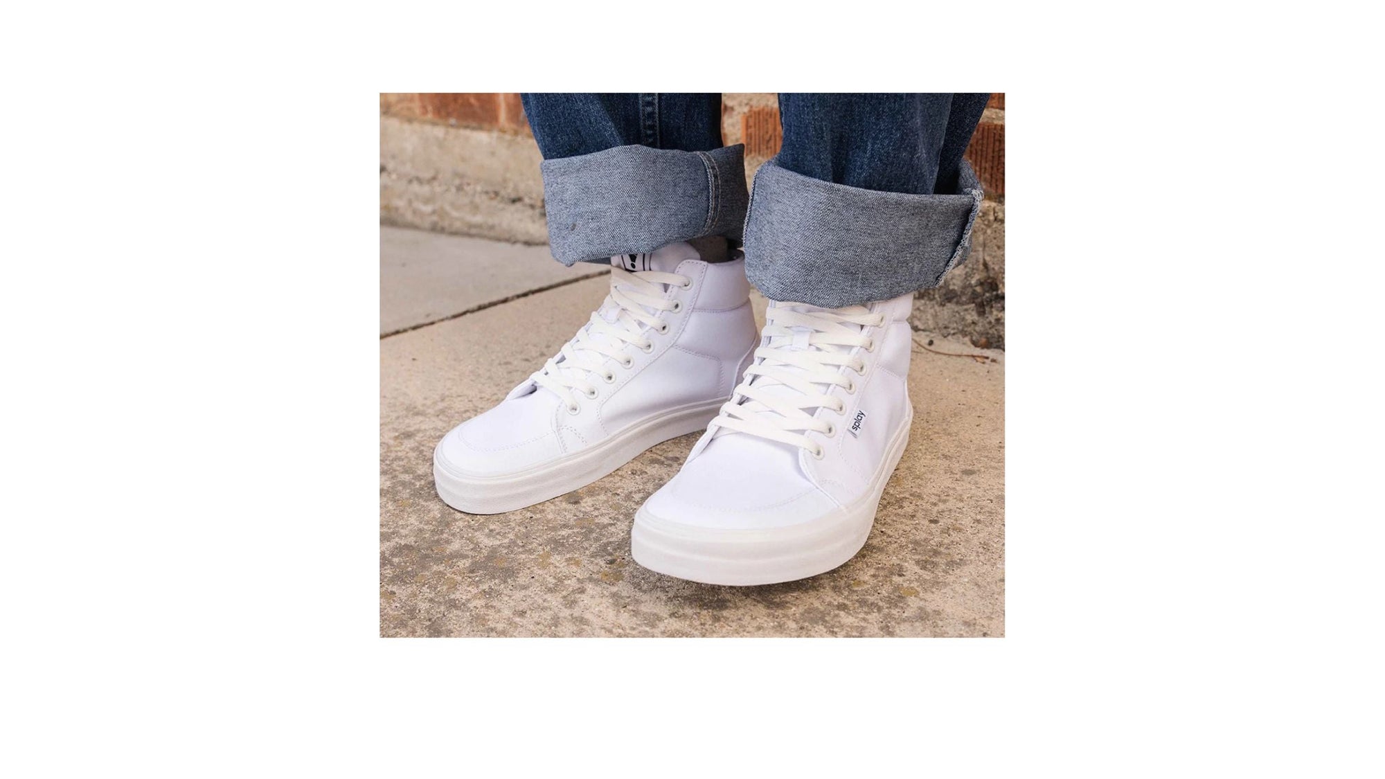 A lady wearing REV HT Canvas Salt Lake and sitting on a roadside curb. 