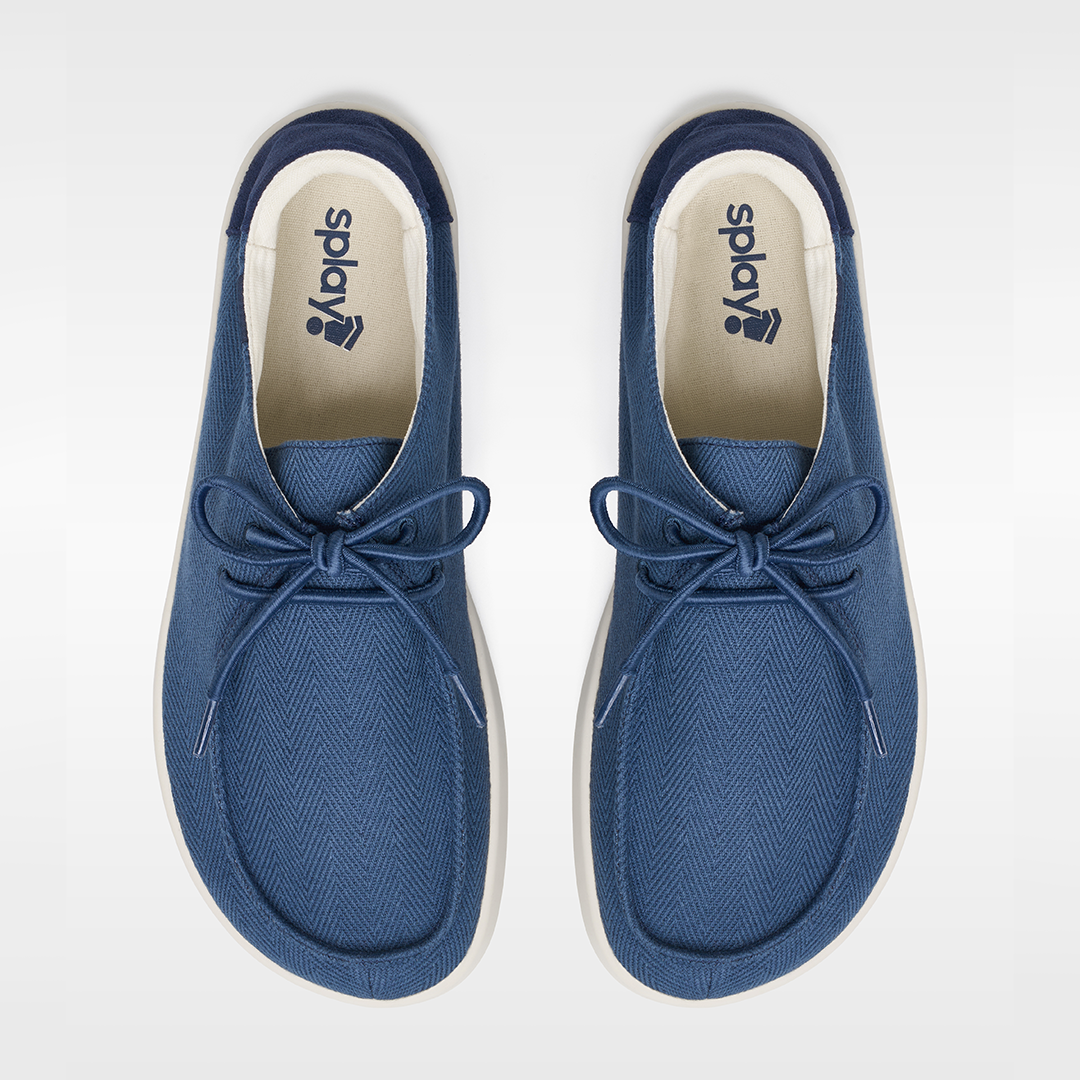 Pair of blue sneakers with a brand logo on a white background