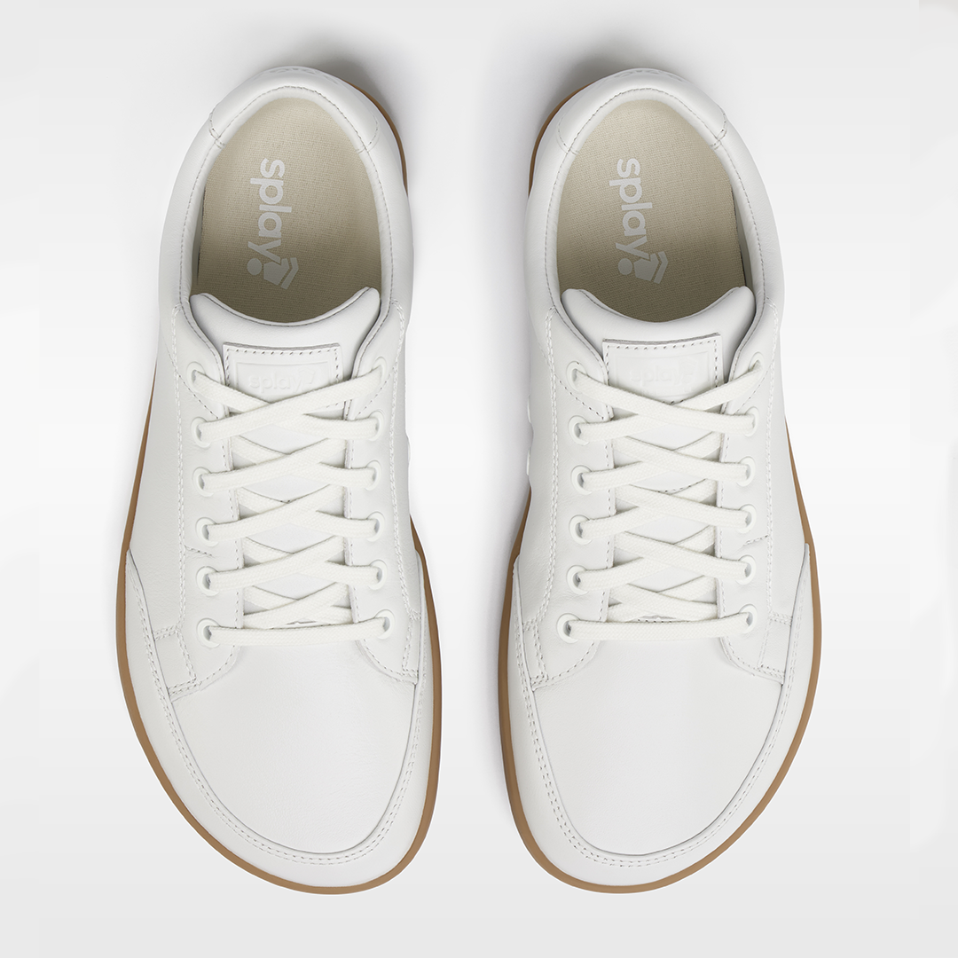 White sneakers with brown soles on a white background