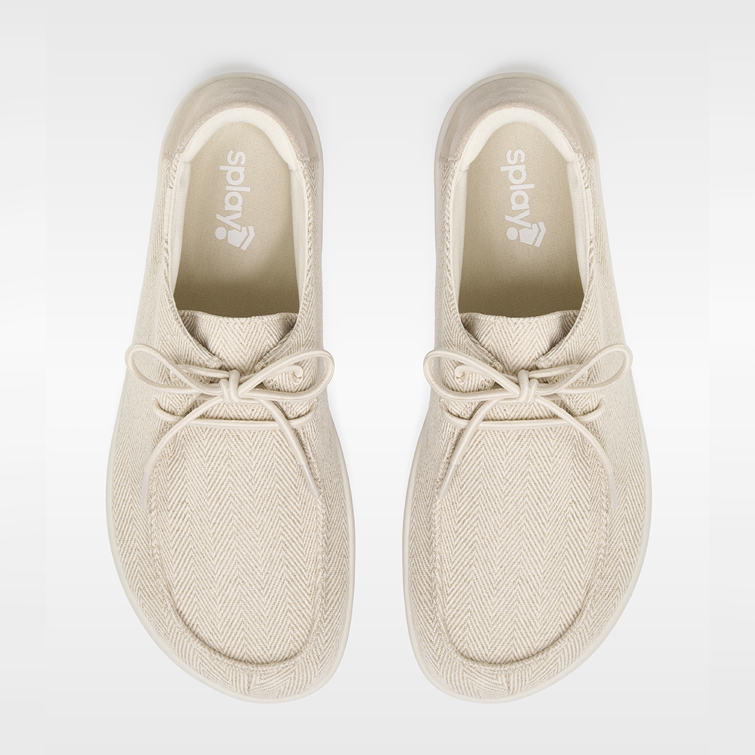 Pair of beige sneakers with 'Splay' branding on a white background