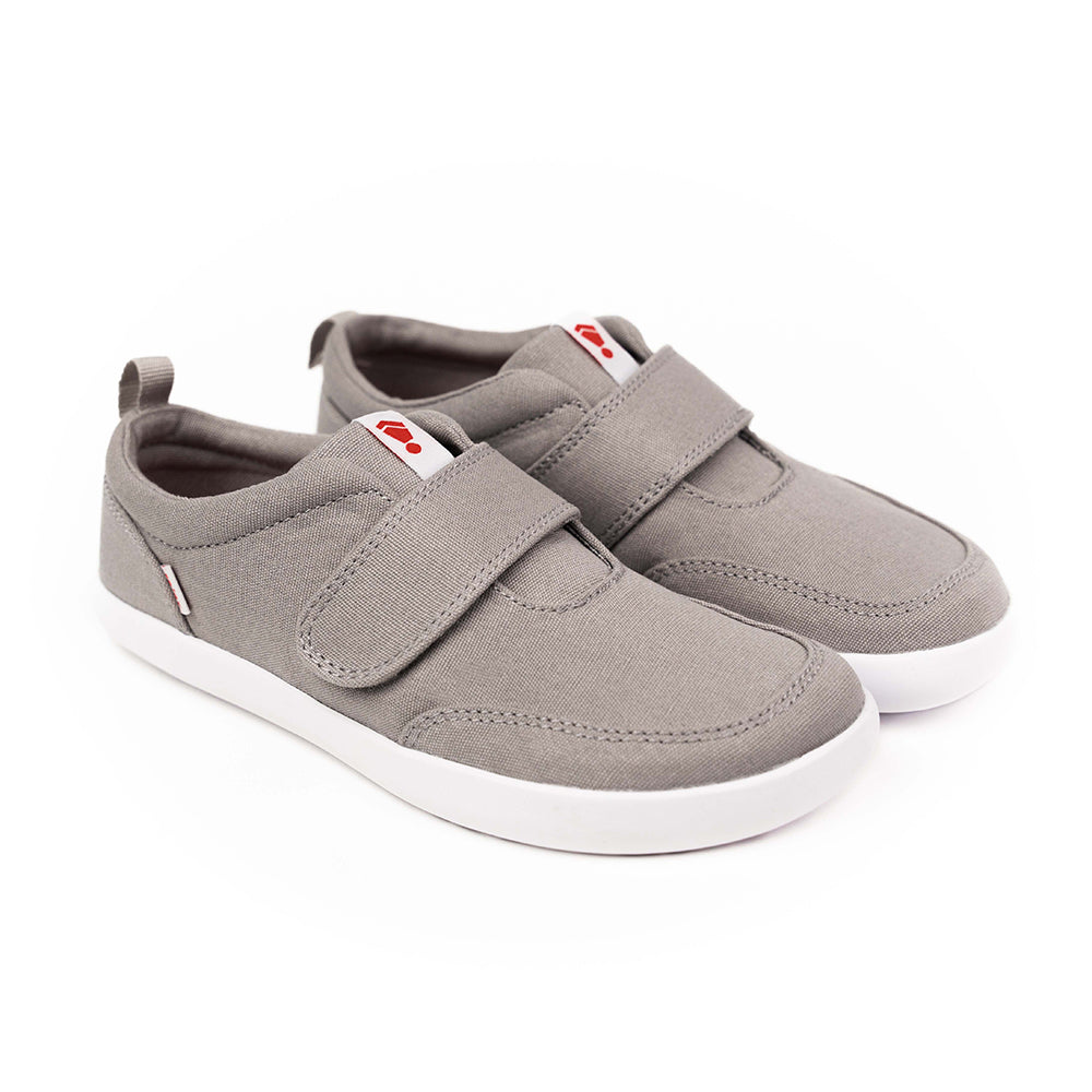 A pair of grey Splay kids' sneakers with a Velcro strap and white soles, featuring the Splay logo in red on the tongue.