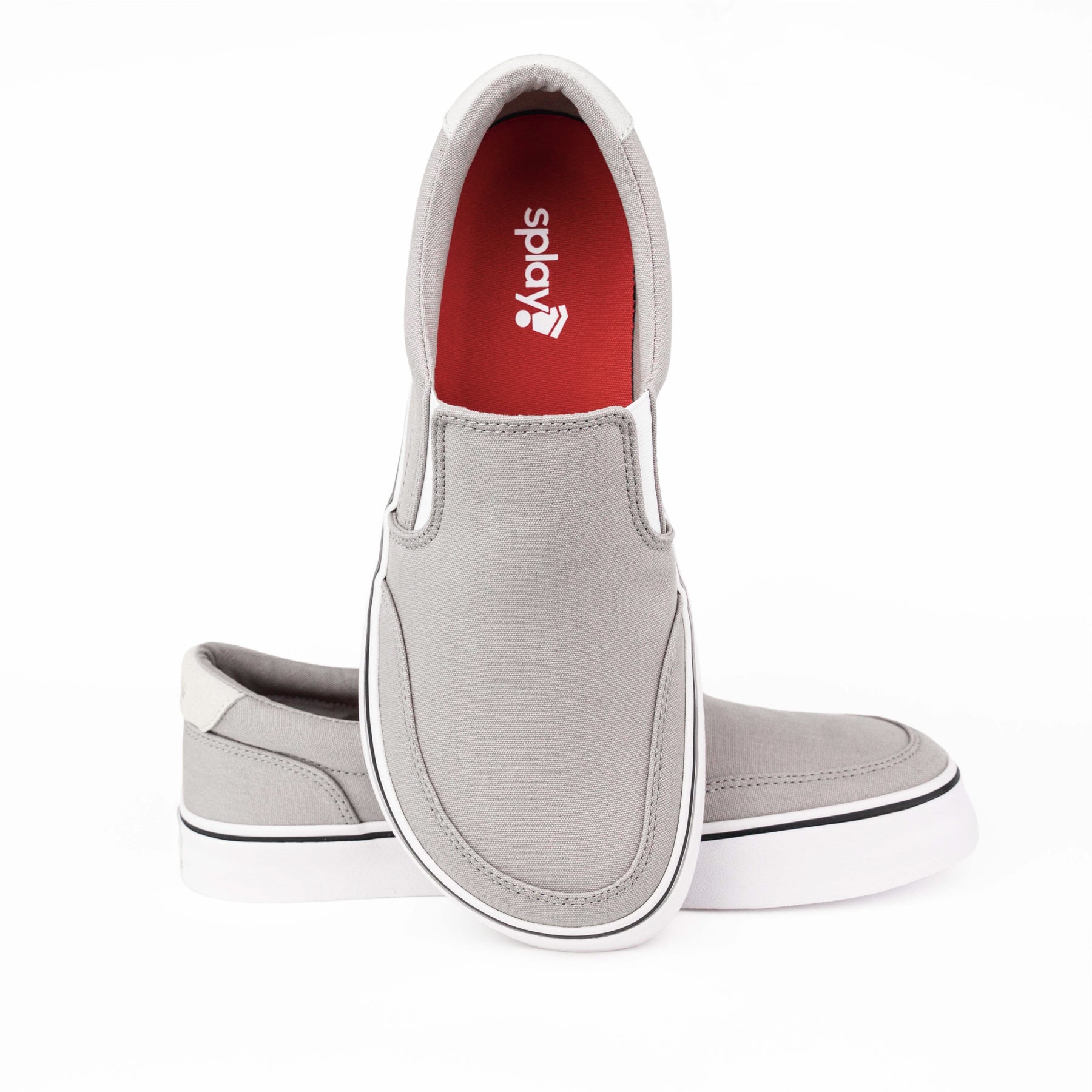 Close-up of light grey Splay STREESTYLE SLIP-ON shoes, featuring a sleek design with a white sole and red interior with the Splay logo.