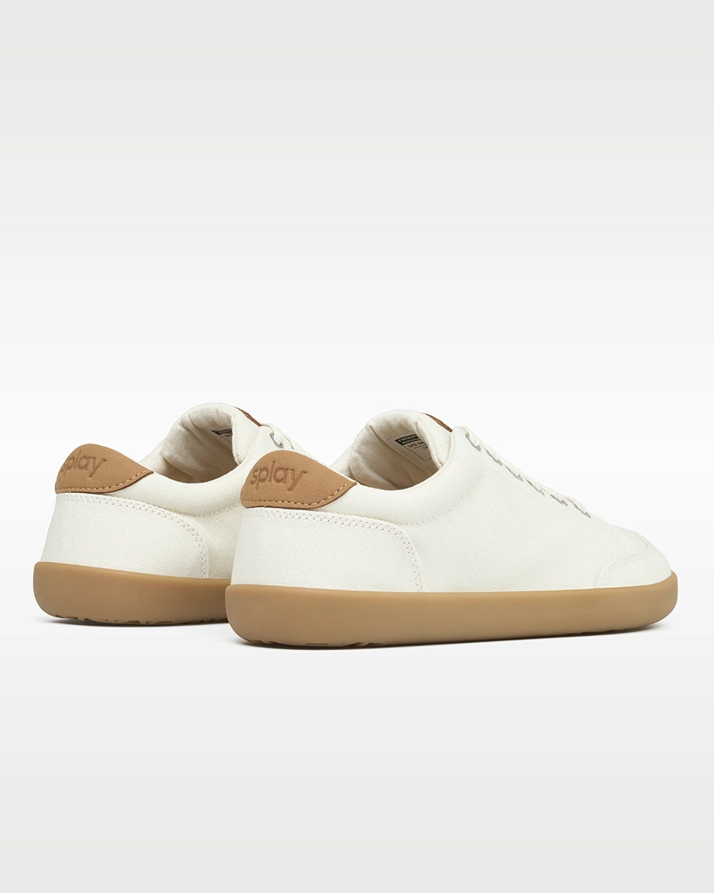 Rear three-quarter view of Splay FREESTYLE Almond '26 cream canvas barefoot sneakers showing tan Splay heel branding.