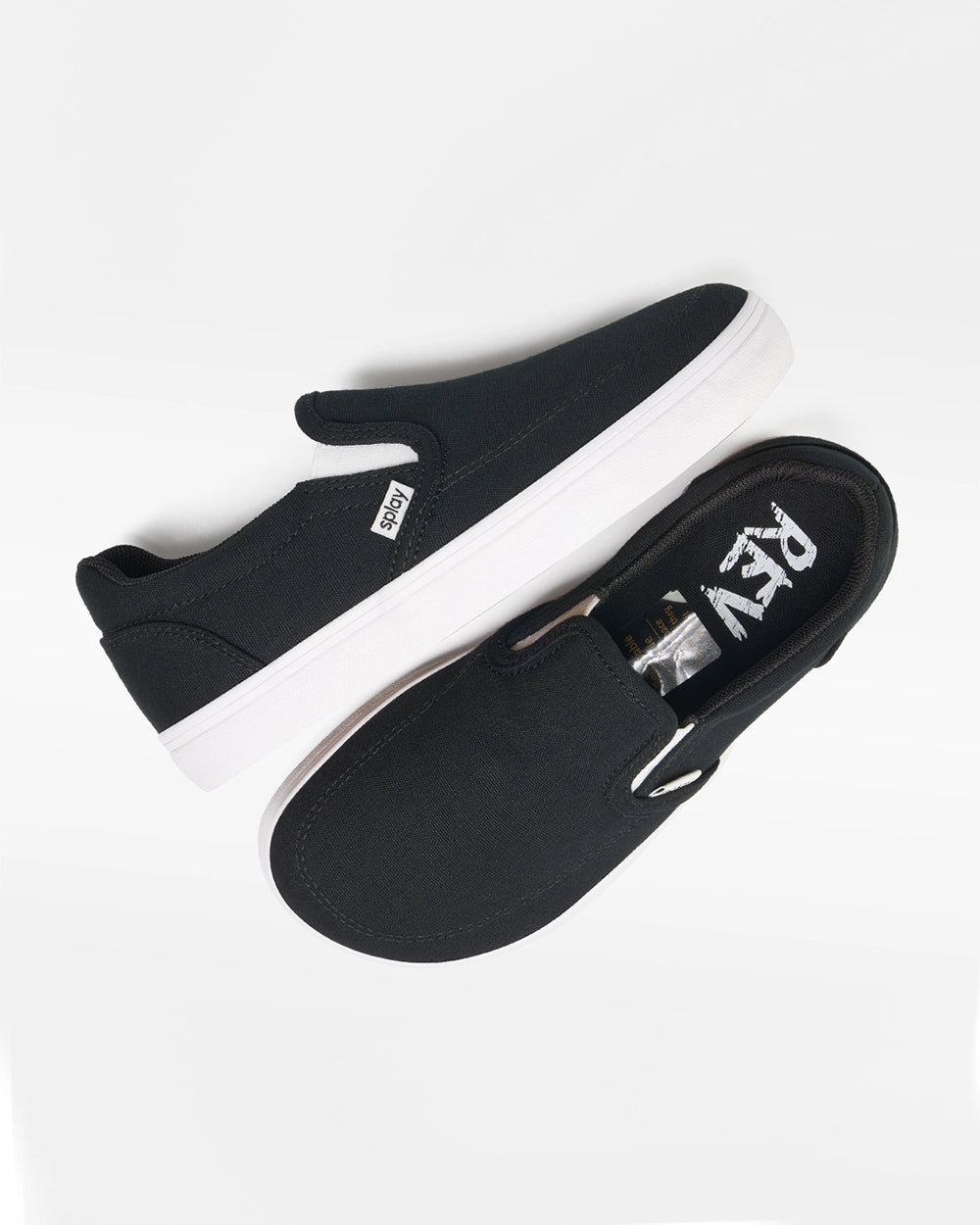 Overhead view of a pair of black Splay Kids REV SO Berlin canvas barefoot slip-on shoes with white soles.

