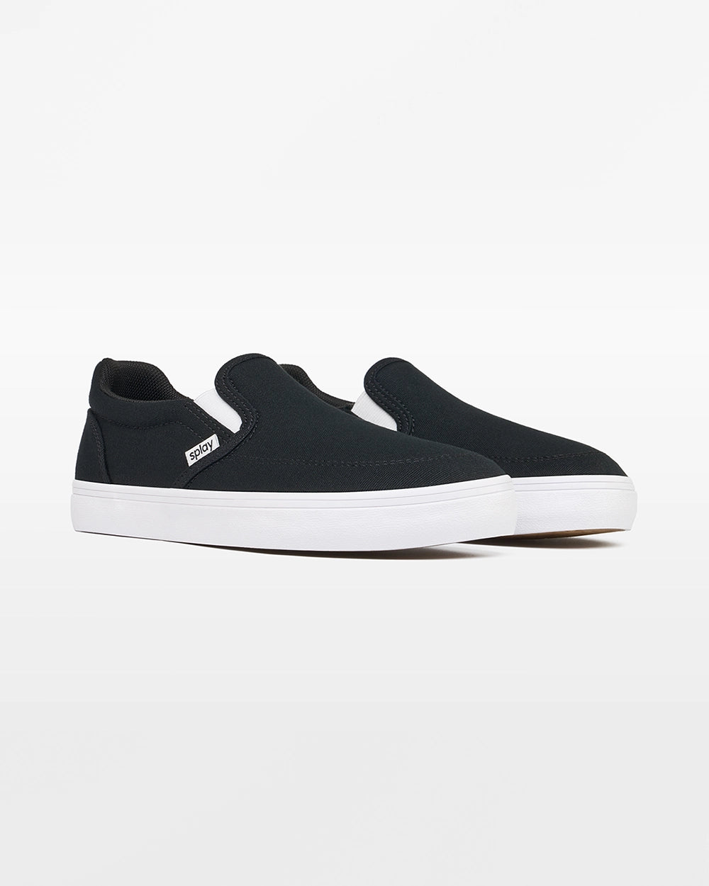 Angled front view of a pair of black Splay Kids REV SO Berlin canvas barefoot slip-on shoes with white soles.