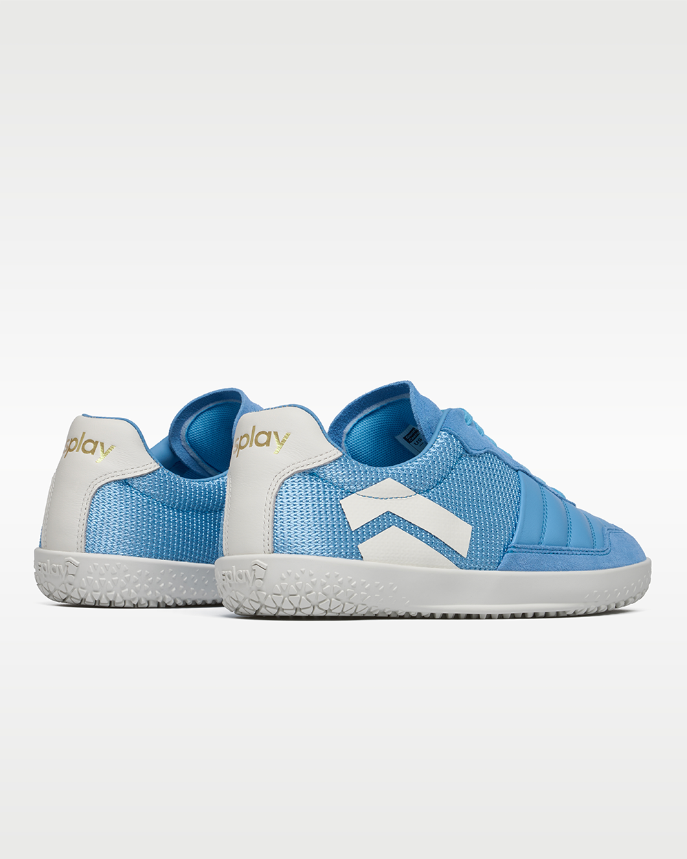 Splay Dominari Caelum indoor soccer shoe for turf and court, sky blue with white chevron and white outsole, pair, heel view with white heel tabs