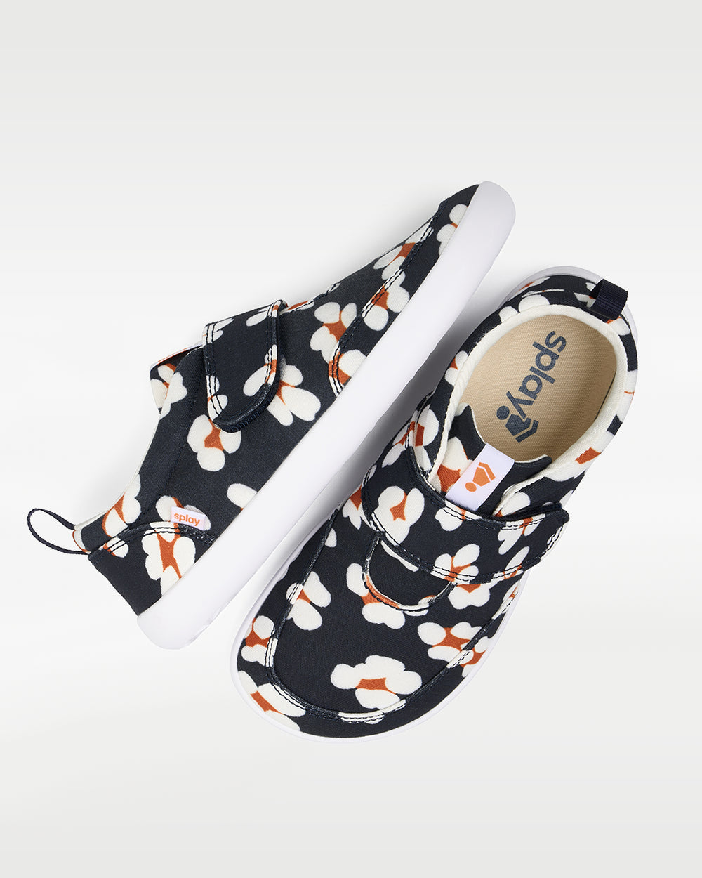 Splay Explore Kids Daisy barefoot shoes — kids' low-top shoe with a hook-and-loop strap, pair shot from above, one shoe tipped up to show the insole