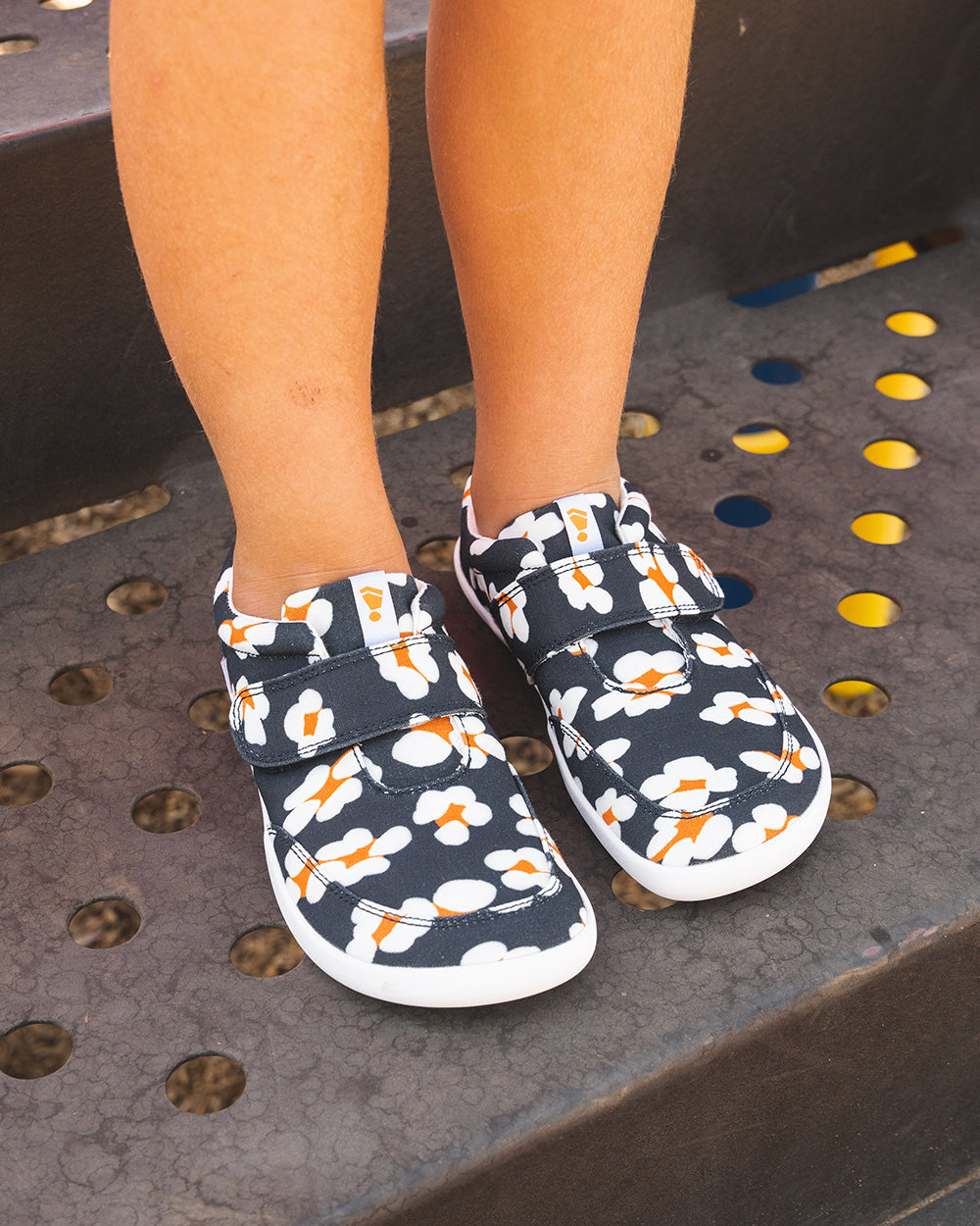 Splay Explore Kids Daisy barefoot shoes — kids' low-top shoe with a hook-and-loop strap, lifestyle photo, the shoes shown in use outdoors