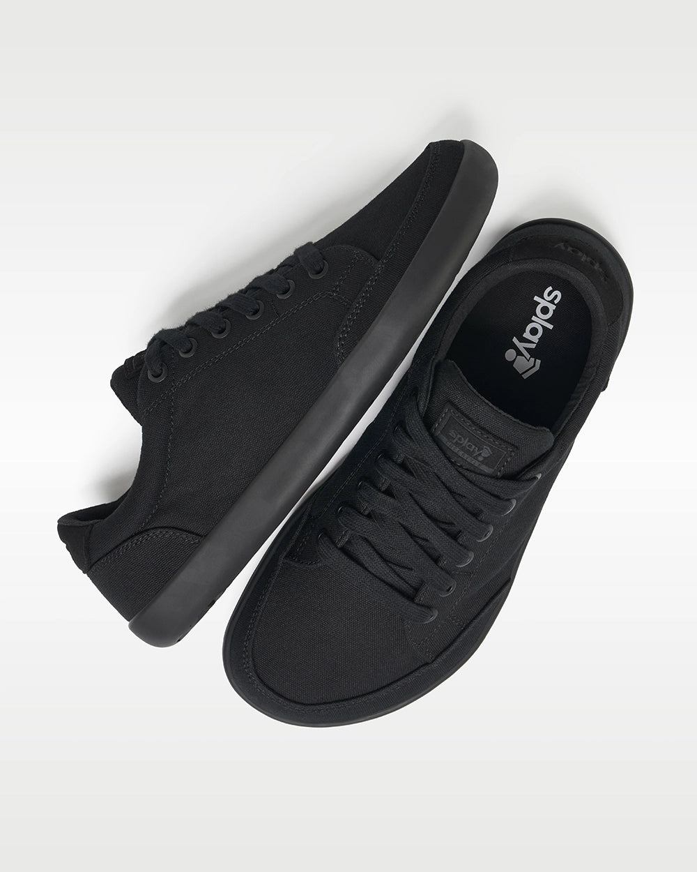 Top and side view of Splay FREESTYLE Jet '26 black canvas barefoot sneakers with black soles and Splay-branded insoles.