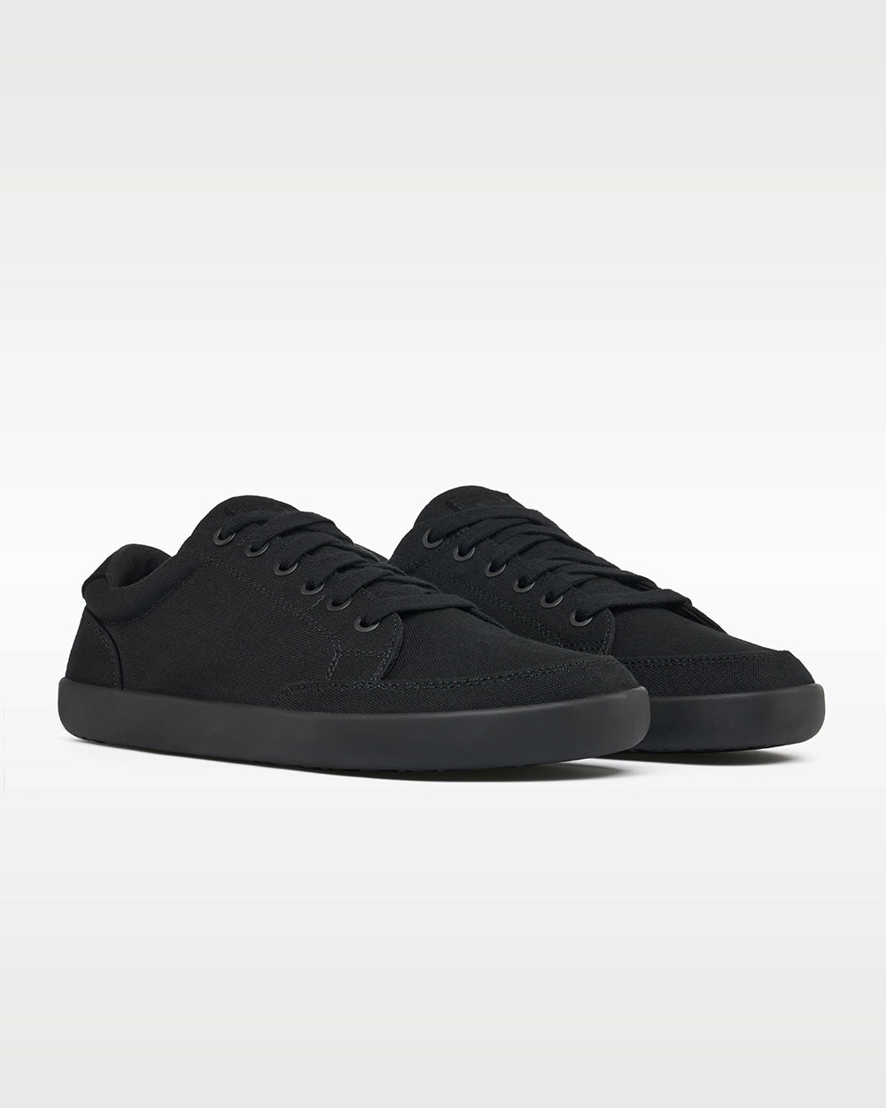 Front three-quarter view of a pair of Splay FREESTYLE Jet '26 all-black canvas barefoot sneakers.