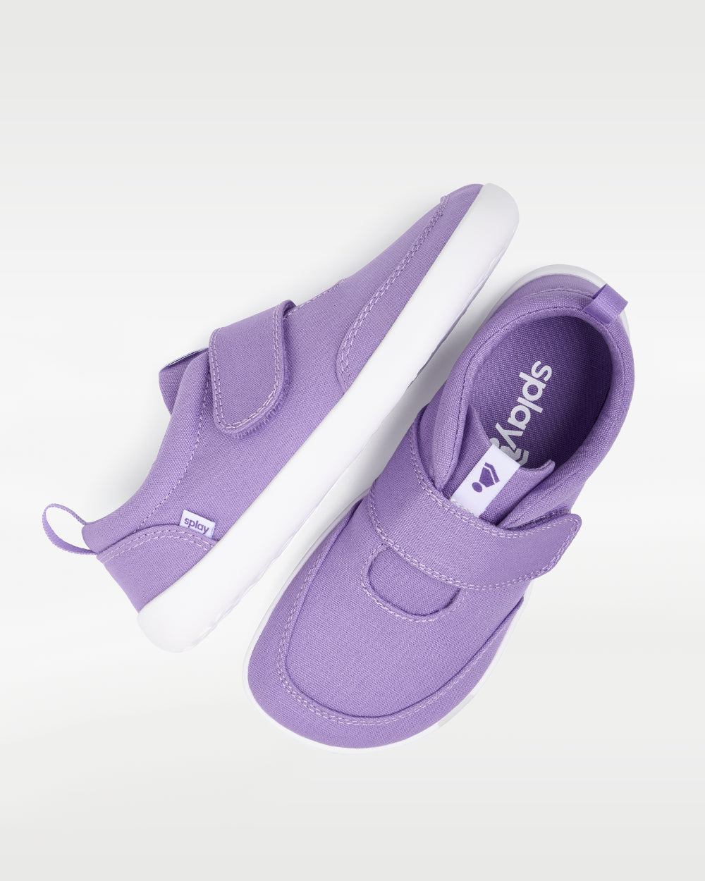 Splay Explore Kids Lavender barefoot shoes — kids' low-top shoe with a hook-and-loop strap, pair shot from above, one shoe tipped up to show the insole