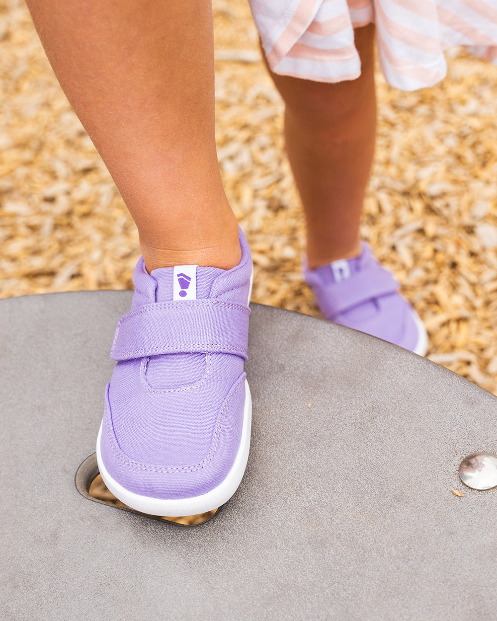 Splay Explore Kids Lavender barefoot shoes — kids' low-top shoe with a hook-and-loop strap, lifestyle photo, the shoes shown in use outdoors