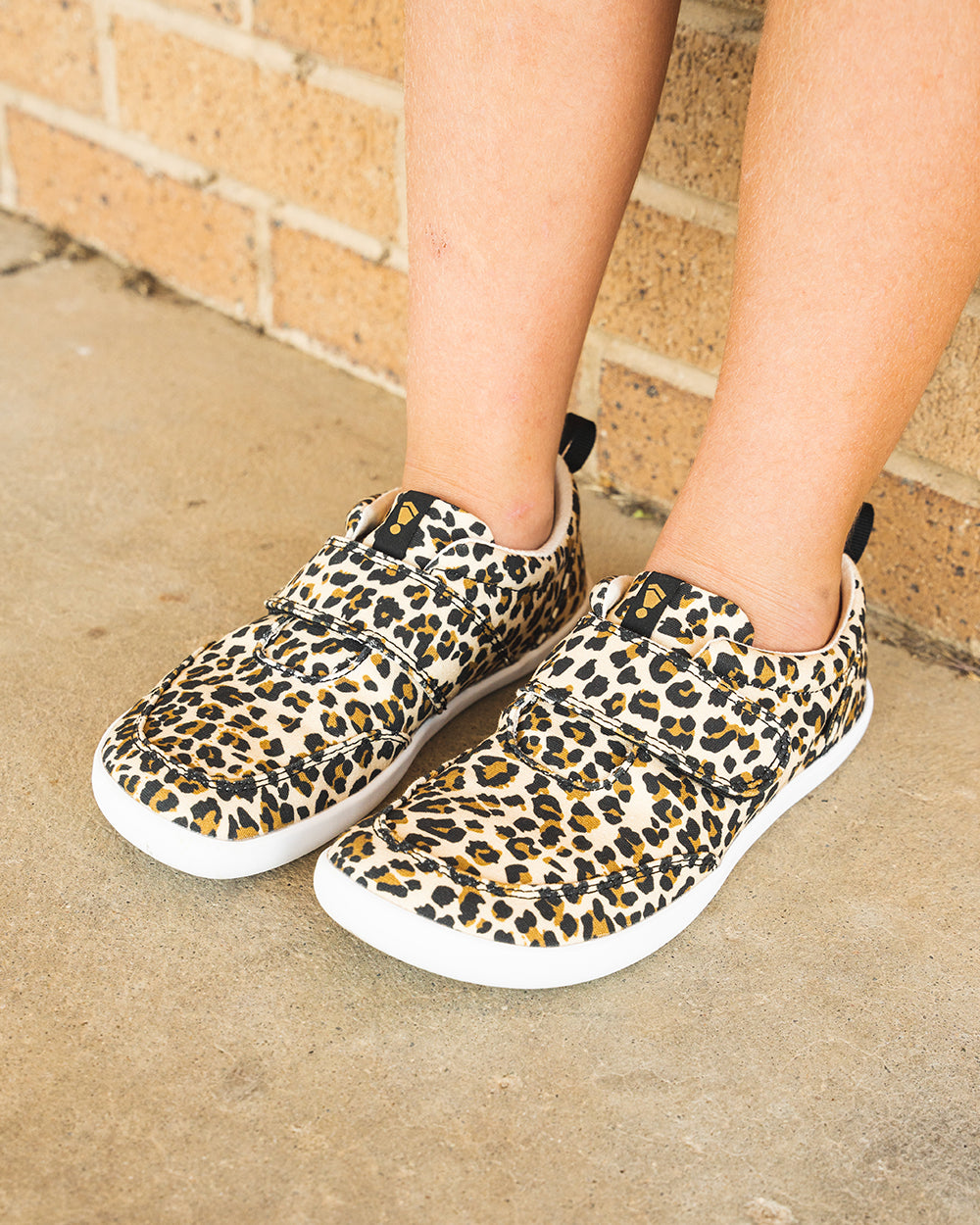 Splay Explore Kids Leopard barefoot shoes — kids' low-top shoe with a hook-and-loop strap, lifestyle photo, the shoes shown in use outdoors
