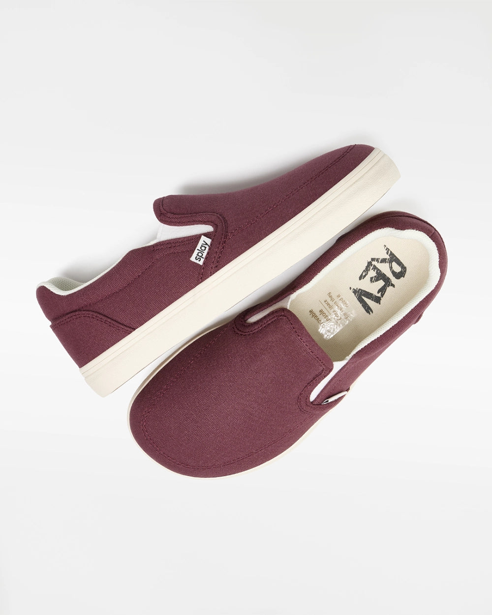 Overhead view of a pair of burgundy Splay Kids REV SO Madrid canvas barefoot slip-on shoes with white soles.
