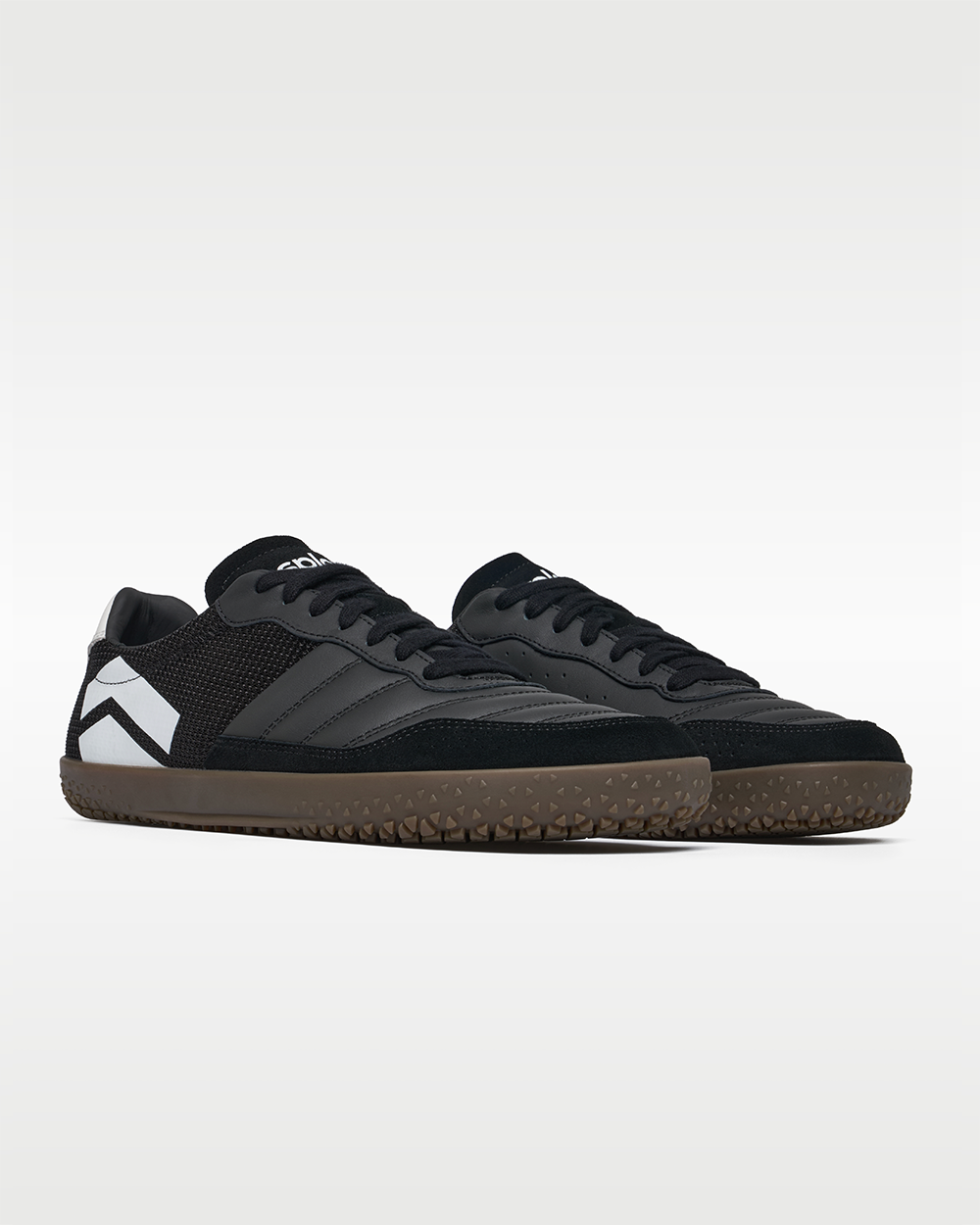 DOMINARI Nox barefoot shoes — low-top indoor soccer shoe with a gum sole, pair in an angled three-quarter view from the front