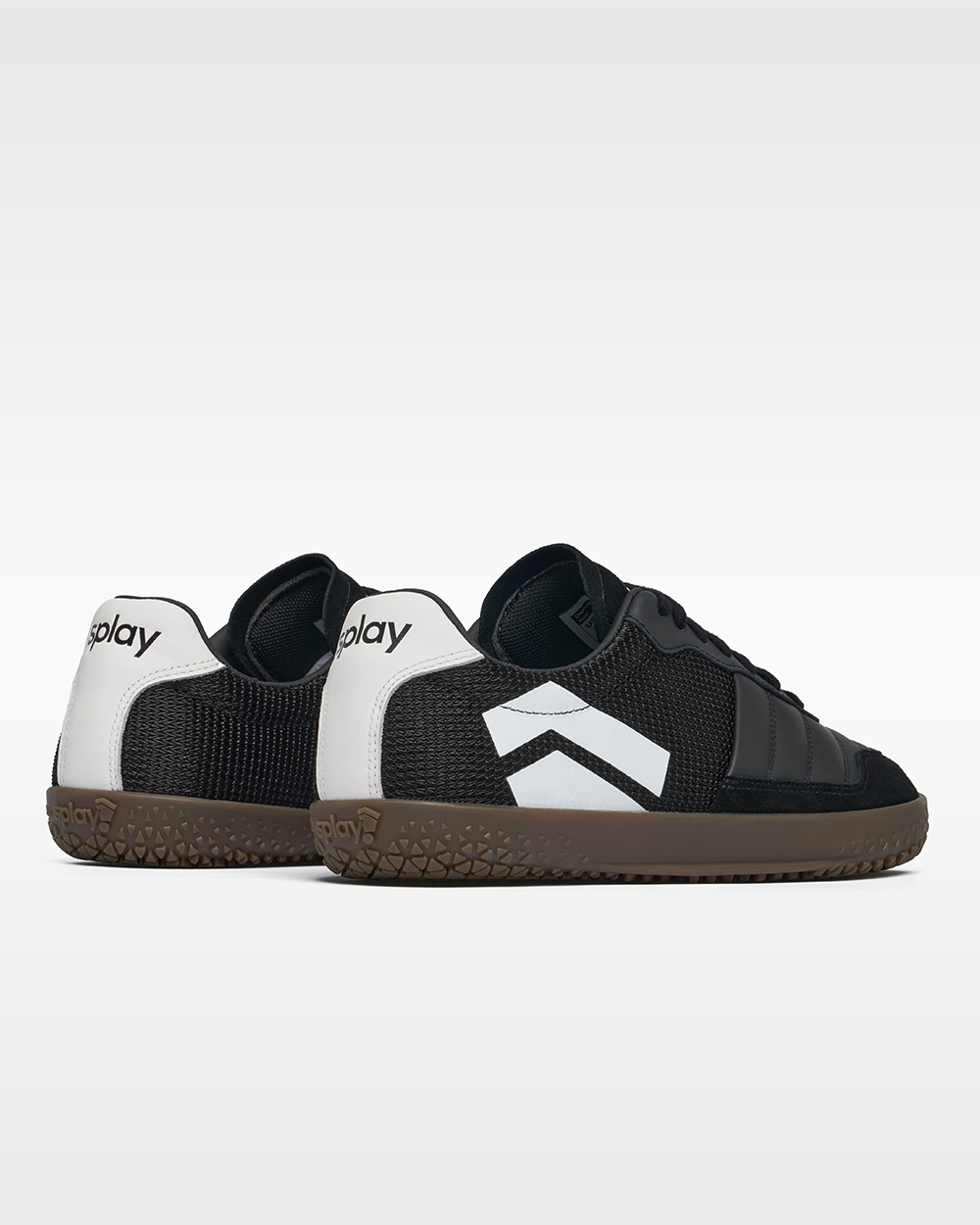 DOMINARI Nox barefoot shoes — low-top indoor soccer shoe with a gum sole, pair viewed from behind, heels toward the camera