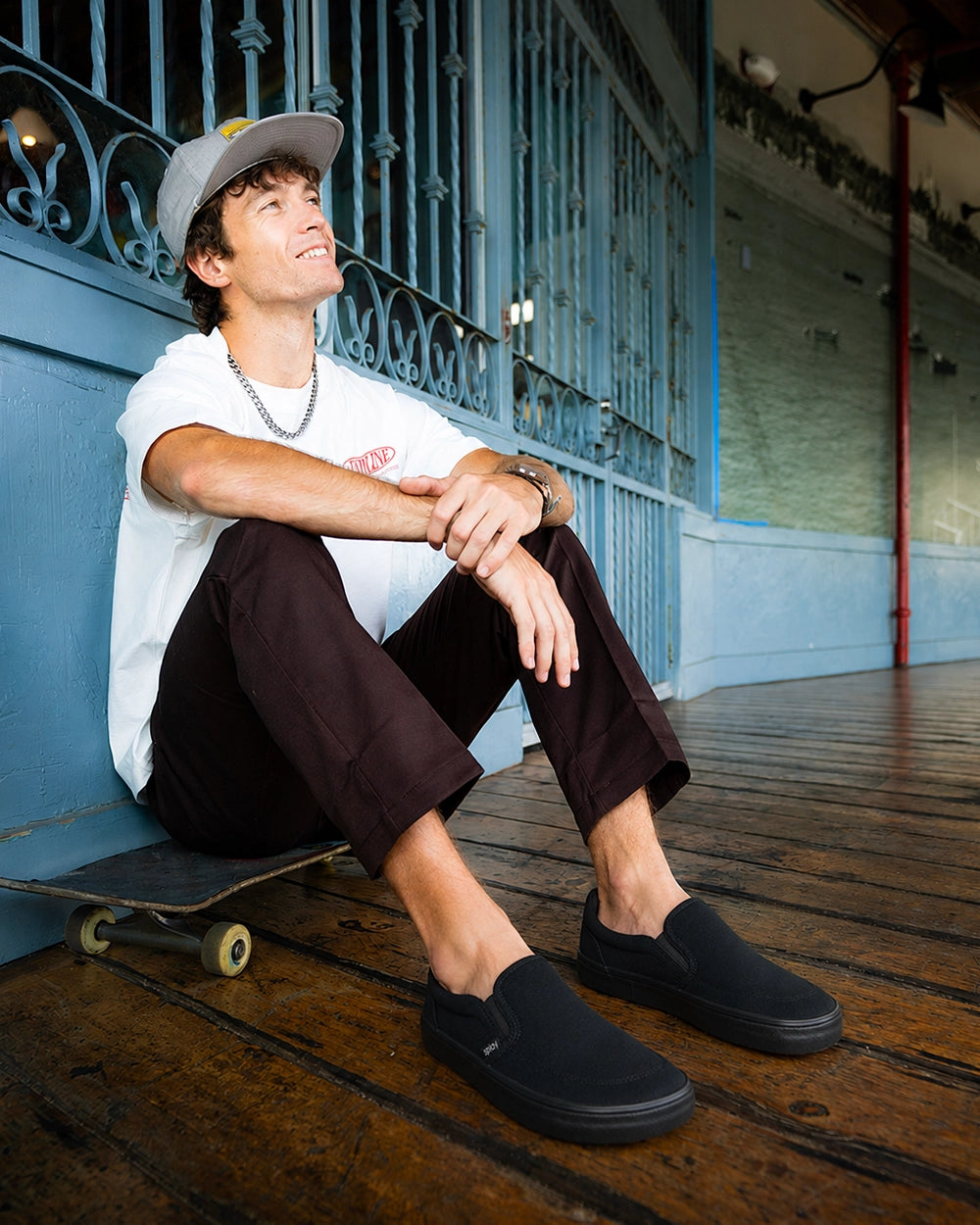 Skater wearing Splay REV SO New York black barefoot shoes while seated on a skateboard