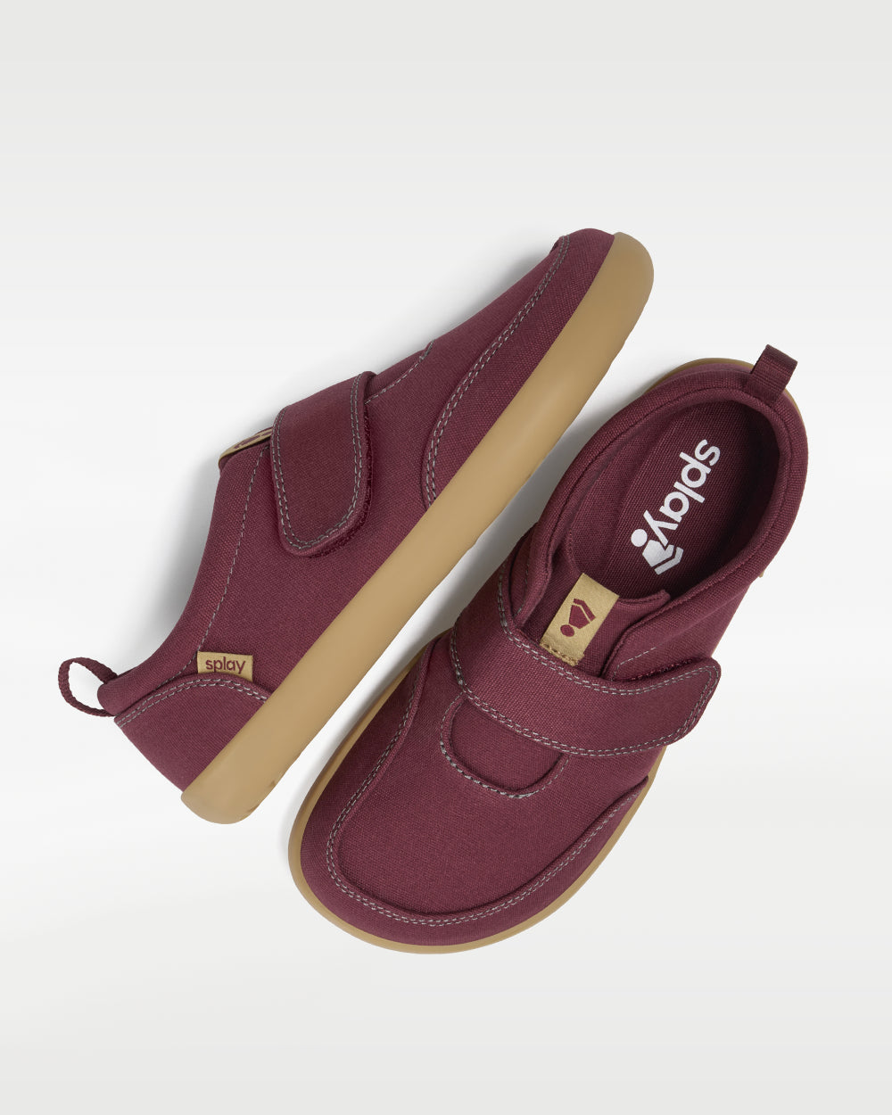 Splay Explore Kids Plum barefoot shoes — kids' low-top shoe with a hook-and-loop strap, pair shot from above, one shoe tipped up to show the insole