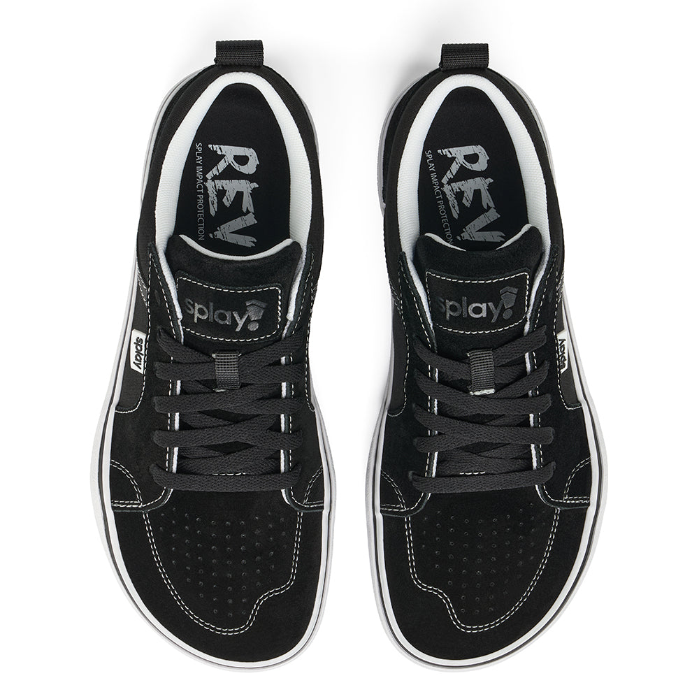 Over a white background, a pair of black REV LTS Los Angeles sneakers viewed from above, showing barefoot-wide toe box, white stitching over black canvas, and “Splay” branding on white over the tongue and side label and the &quot;REV&quot; logo printed on the sockliner. Black laces. 