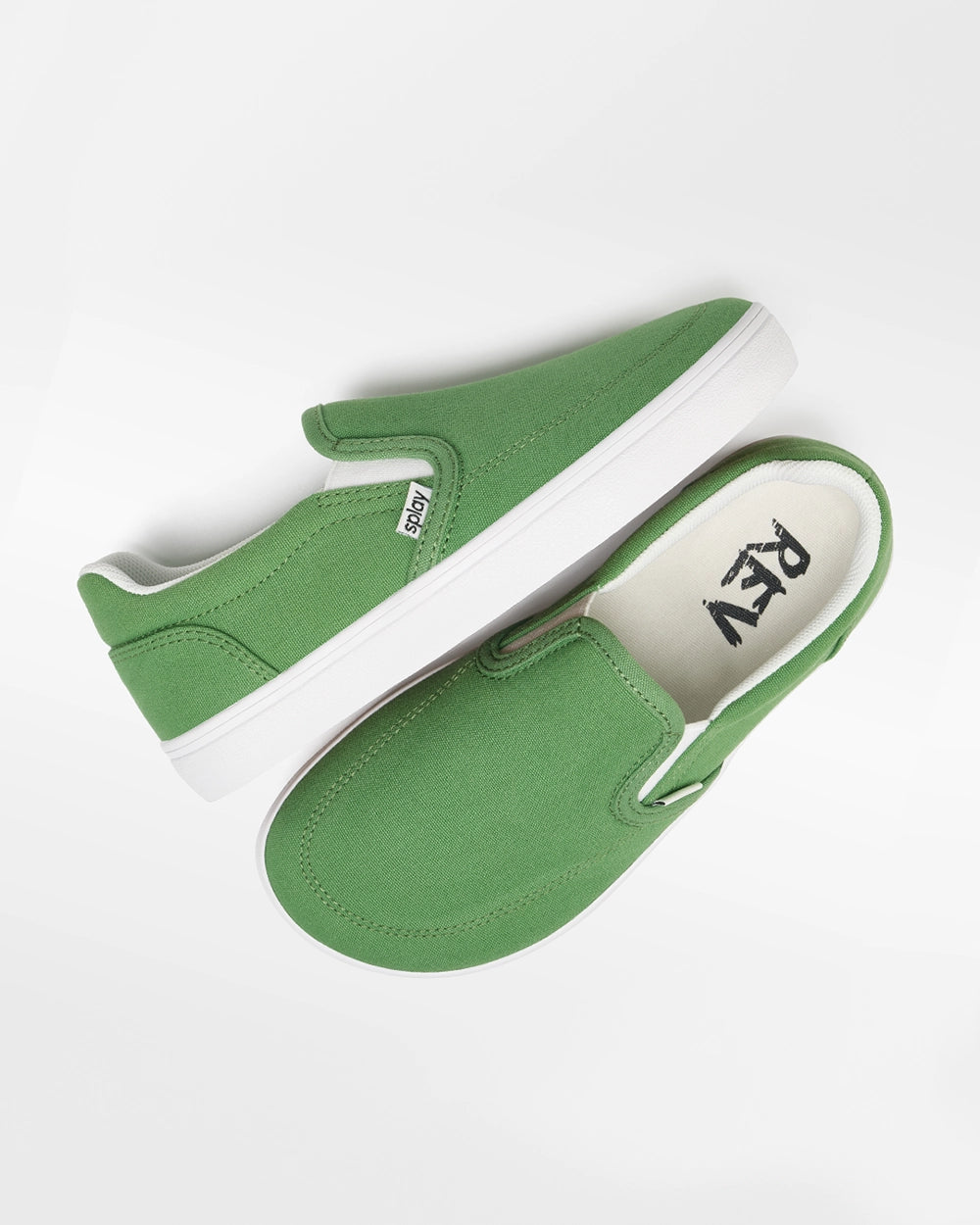 Overhead view of a pair of green Splay Kids REV SO Rio canvas barefoot slip-on shoes with white soles.