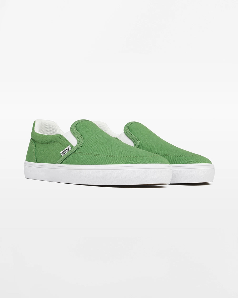 Angled front view of a pair of green Splay Kids REV SO Rio canvas barefoot slip-on shoes with white soles.