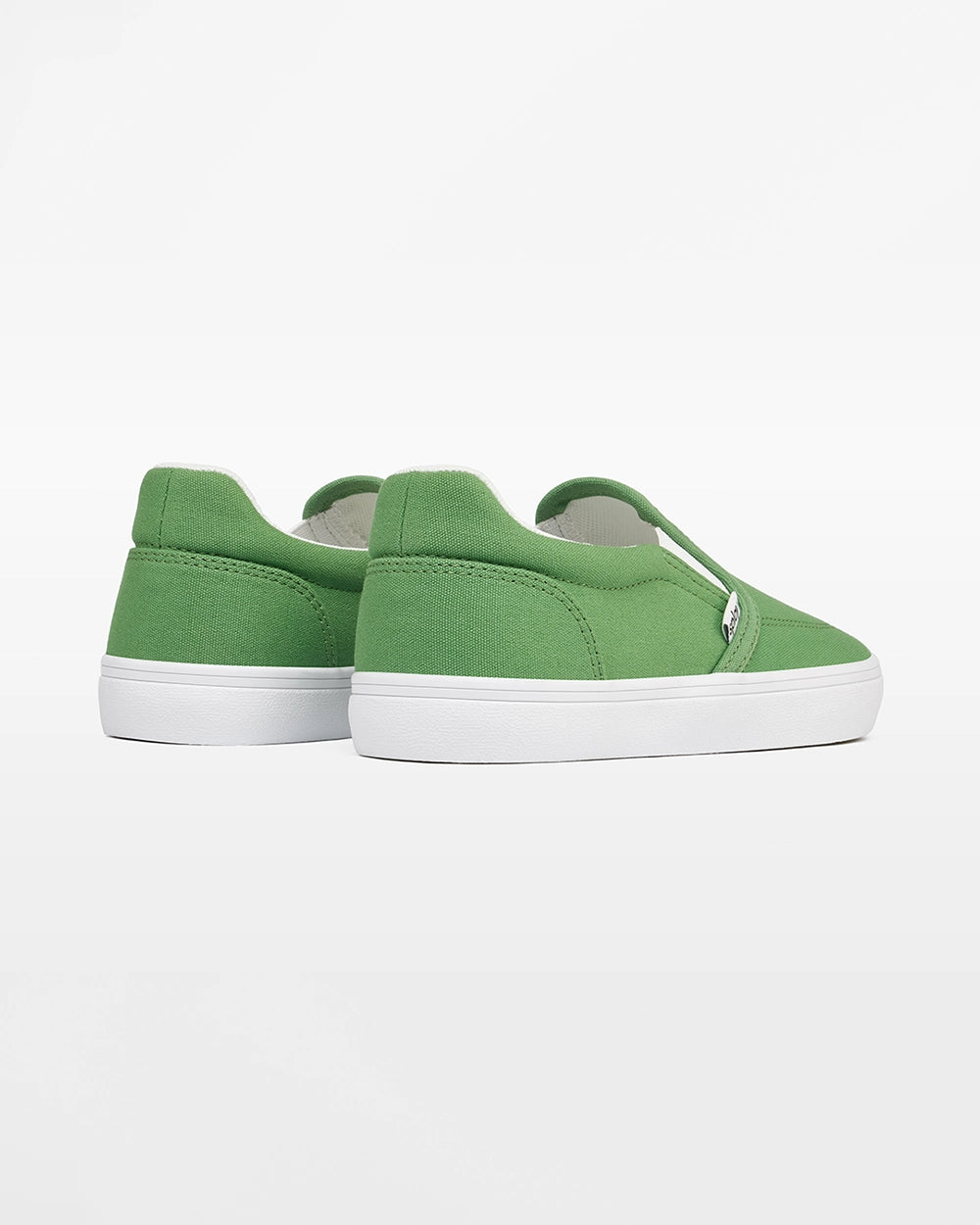 Rear angled view of a pair of green Splay Kids REV SO Rio canvas barefoot slip-on shoes with white soles.