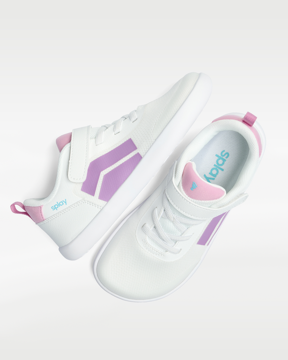 Splay Dash Kids Spark Lilac barefoot shoes — kids' low-top sneaker with a strap and laces, pair shot from above, one shoe tipped up to show the insole