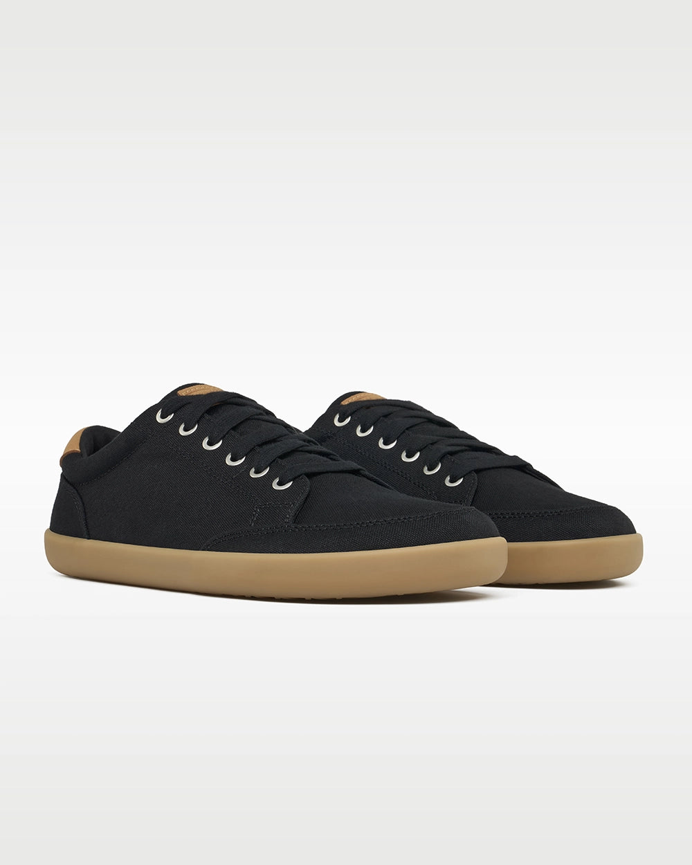 Front three-quarter view of a pair of Splay FREESTYLE Shale '26 black canvas barefoot sneakers with gum soles.