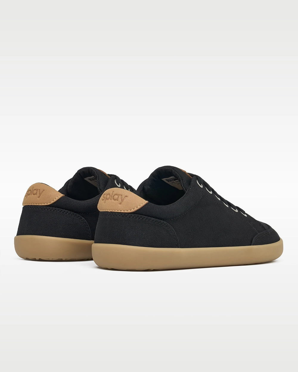 Rear three-quarter view of Splay FREESTYLE Shale '26 black canvas barefoot sneakers showing tan Splay heel branding.