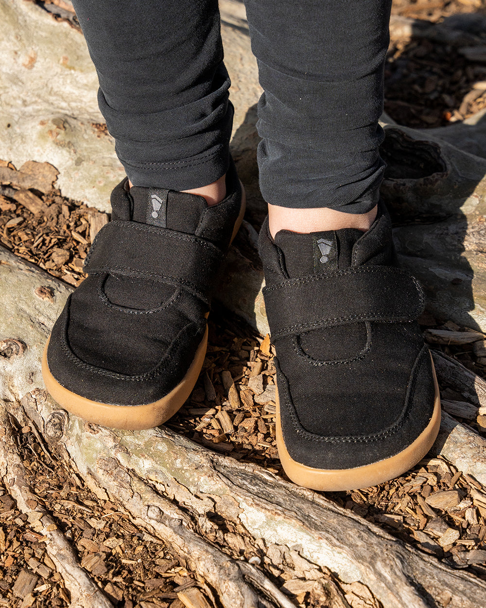 Splay Explore Kids Shale barefoot shoes — kids' low-top shoe with a hook-and-loop strap, lifestyle photo, the shoes shown in use outdoors