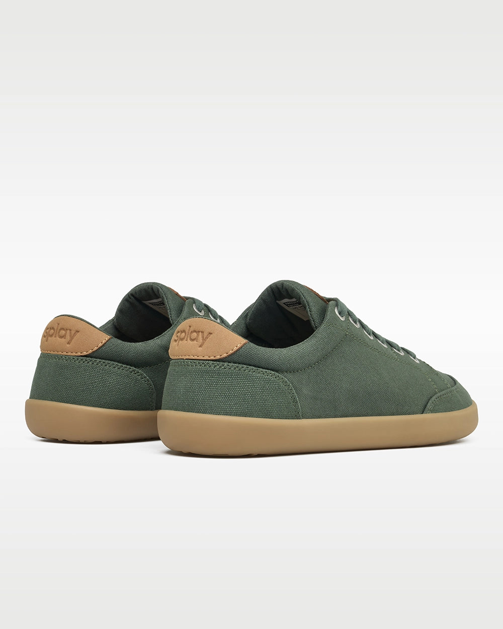 Rear three-quarter view of Splay FREESTYLE Spruce '26 green canvas barefoot sneakers showing tan Splay heel branding.