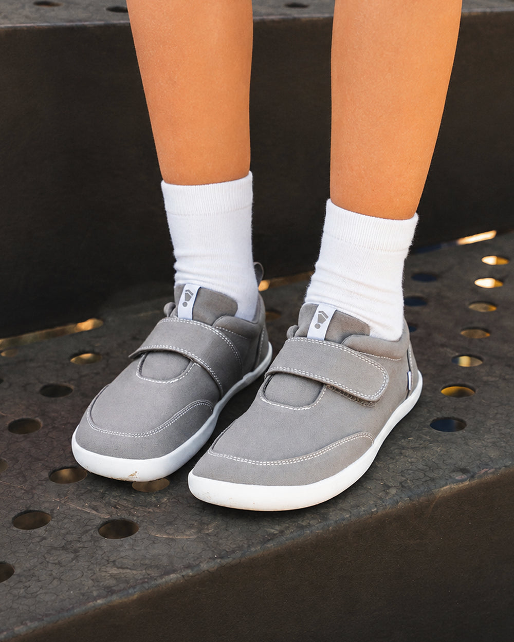 Splay Explore Kids Stone barefoot shoes — kids' low-top shoe with a hook-and-loop strap, lifestyle photo, the shoes shown in use outdoors