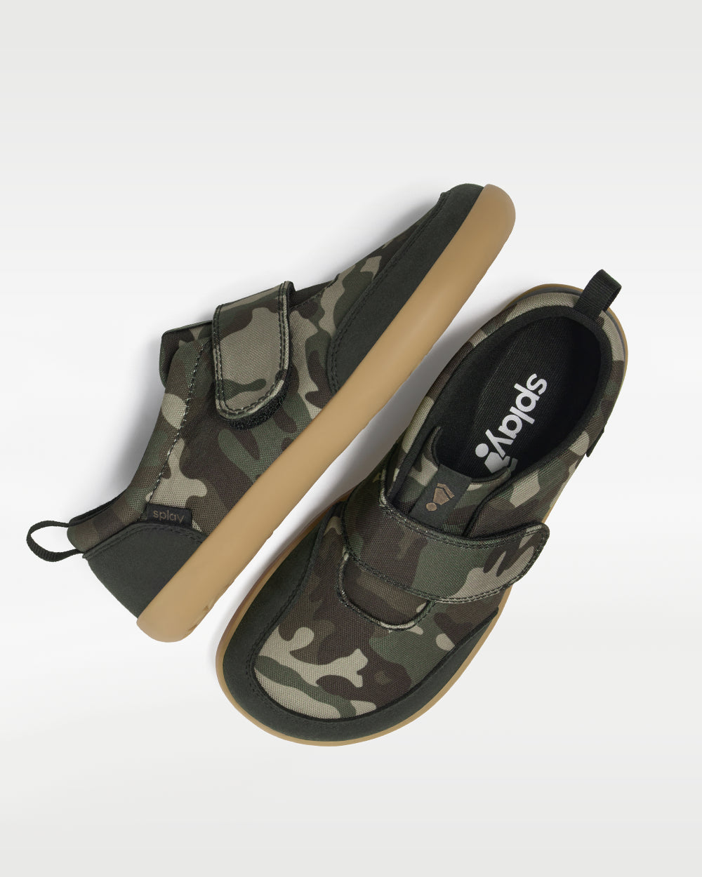 Splay Explore Wild Kids Classic Camo barefoot shoes — kids' low-top shoe with a hook-and-loop strap, pair shot from above, one shoe tipped up to show the insole