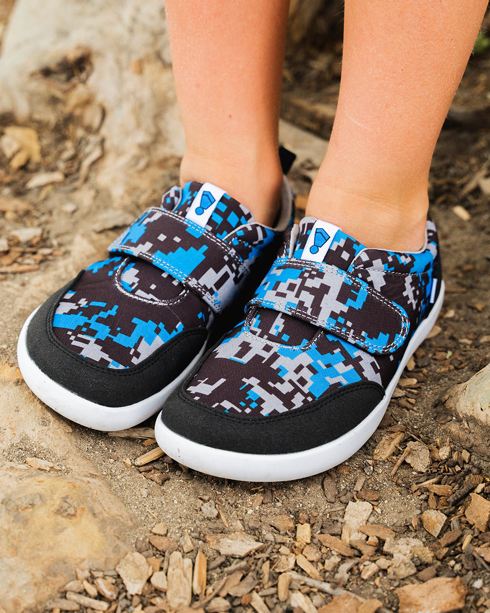 Splay Explore Wild Kids Digicam Blue barefoot shoes — kids' low-top shoe with a hook-and-loop strap, lifestyle photo, the shoes shown in use outdoors