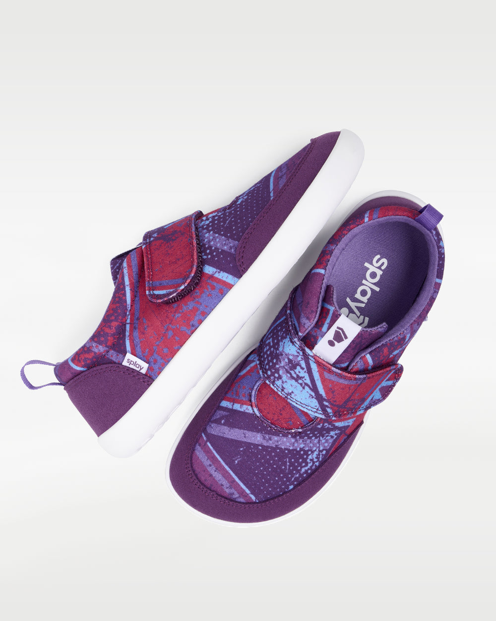 Splay Explore Wild Kids Purple Pop barefoot shoes — kids' low-top shoe with a hook-and-loop strap, pair shot from above, one shoe tipped up to show the insole