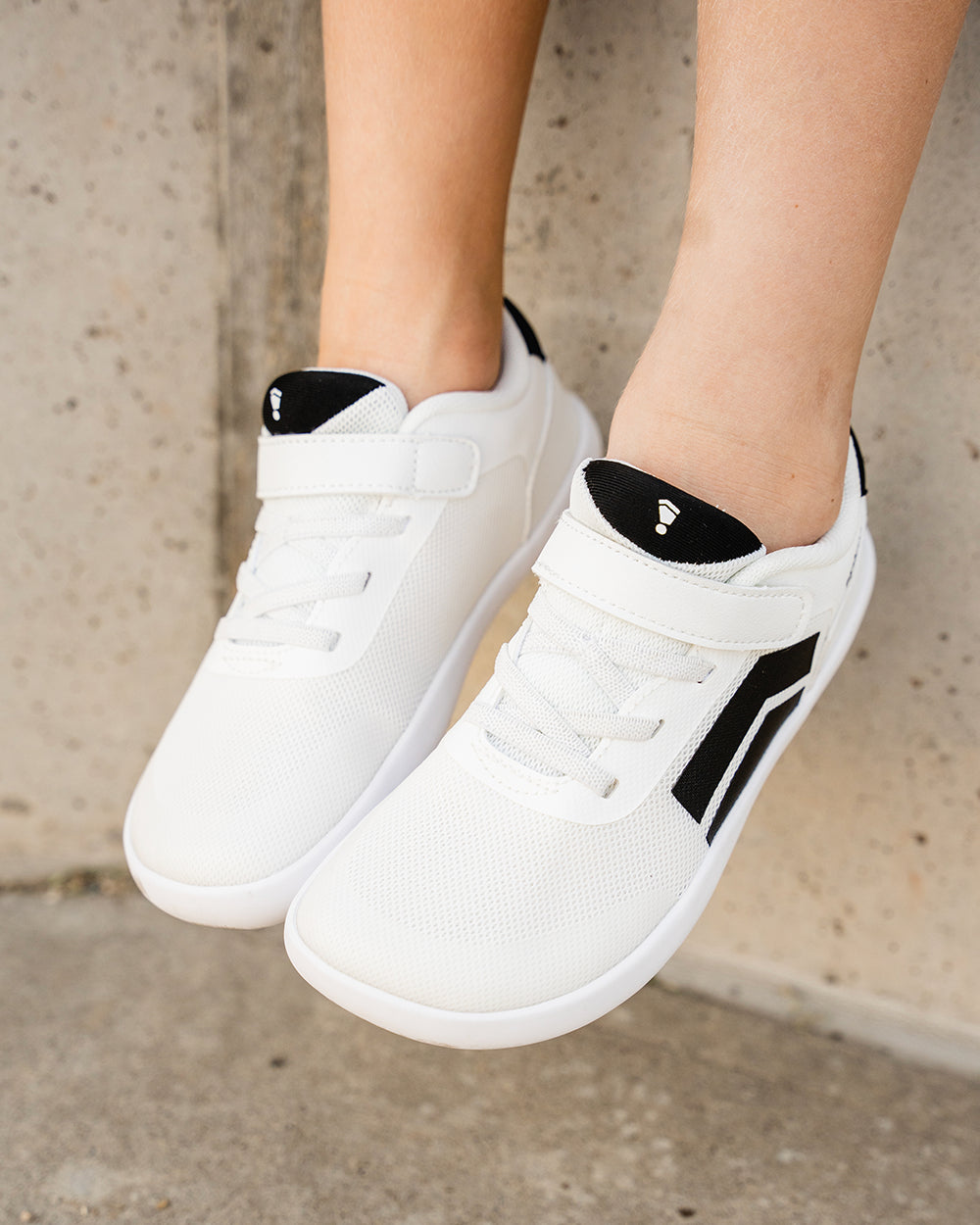 Splay Dash Kids Spark White barefoot shoes — kids' low-top sneaker with a strap and laces, lifestyle photo, the shoes shown in use outdoors